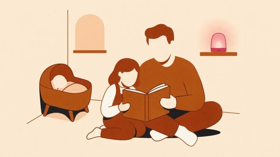 Father reading a bedtime story to his preschooler on the bedroom floor while a baby sleeps in a bassinet nearby